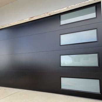 a black garage door with three windows