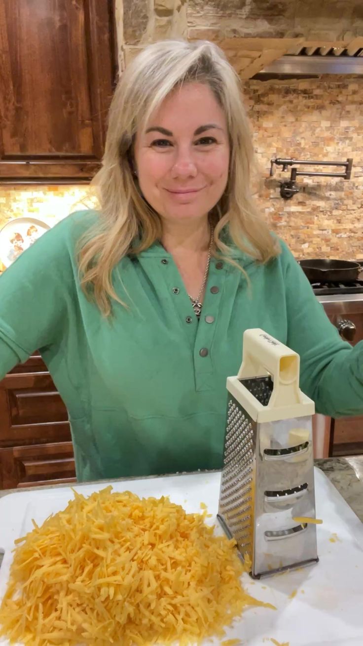 a woman sitting at a table with grated cheese