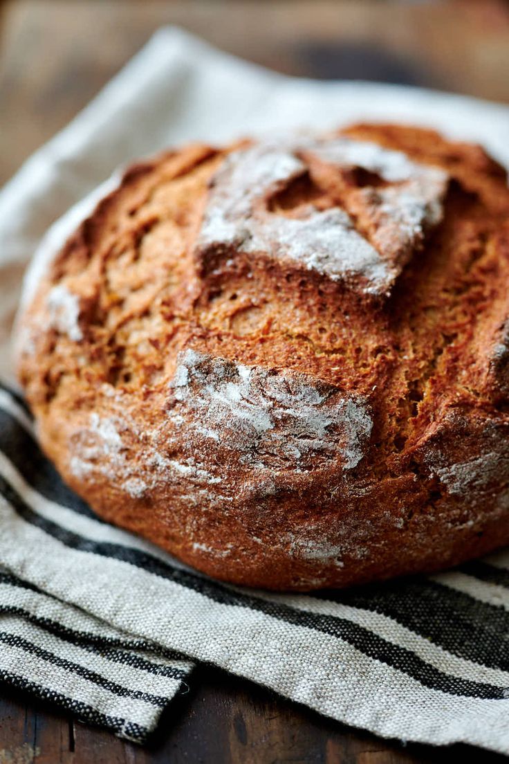 a loaf of sourdough rye bread sitting on top of a wooden table with text overlay