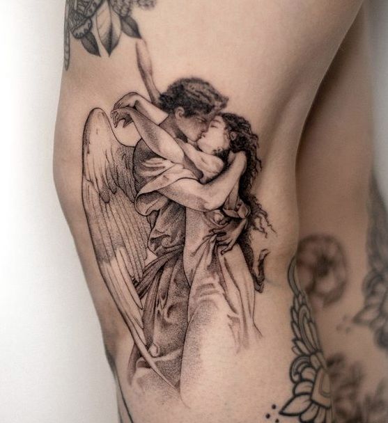 an angel tattoo on the side of a woman's thigh