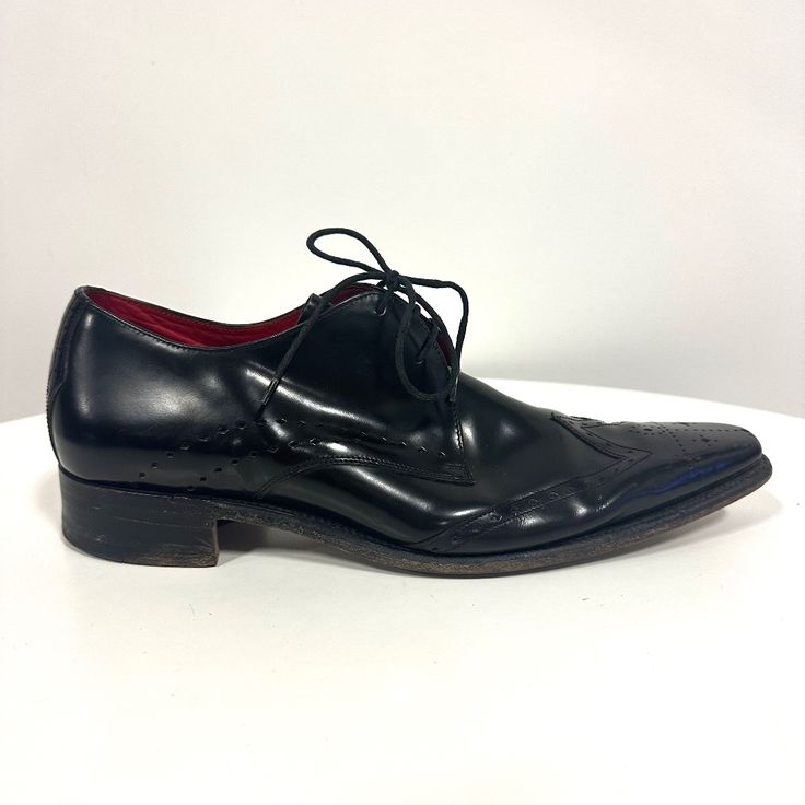 Designer: Jeffrey West Size: 10 Made In England Black Leather Lace Up Wingtips Pre-Owned Great Condition, Like New. Black Wingtip Lace-up Shoes For Formal Occasions, Black Pointed Toe Formal Lace-up Shoes, Black Calf Leather Wingtip Shoes, Black Lace-up Dress Shoes With Leather Lining, Black Leather Wingtip Shoes With Leather Sole, Black Pointed Toe Dress Shoes With Rubber Sole, Designer Black Cap Toe Oxfords, Designer Black Oxfords With Rubber Sole, Black Pointed Toe Lace-up Business Shoes