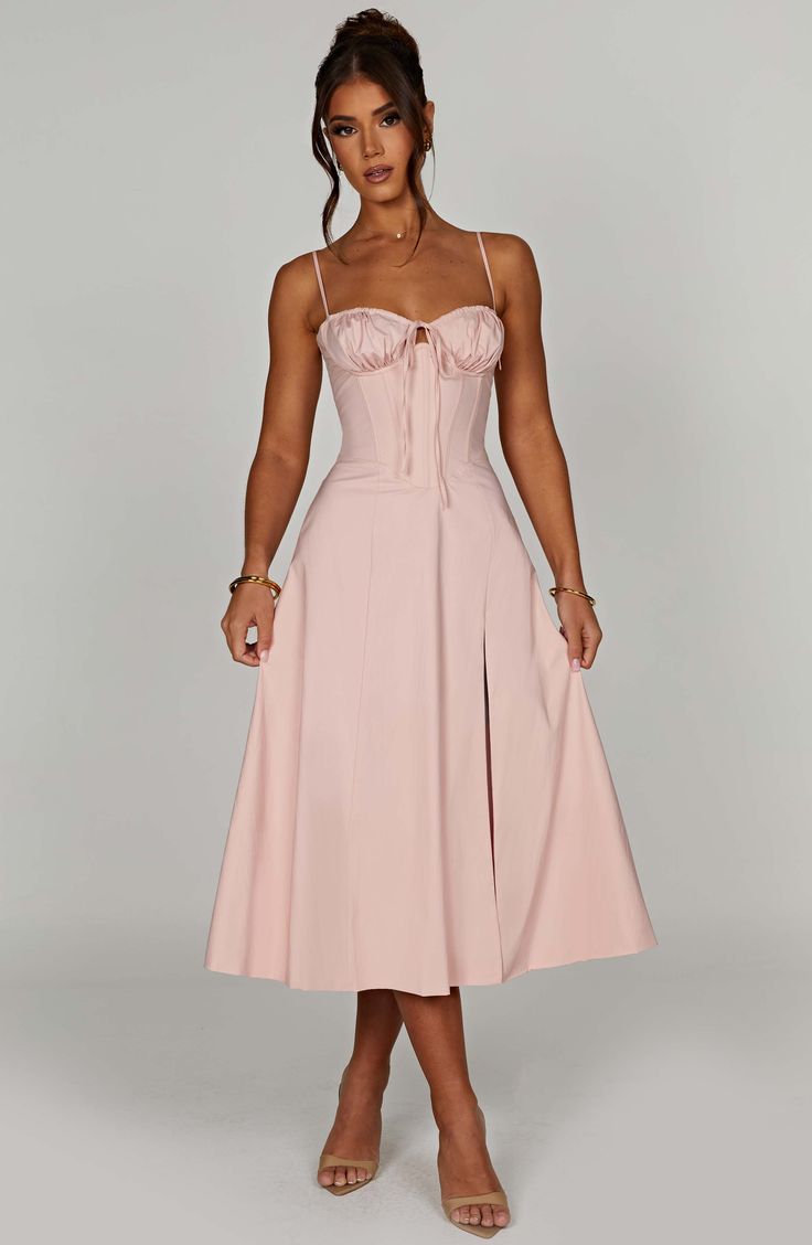 The dreamy Deanna dress is ultra feminine, made in our premium woven cotton blend fabric that feels as good as it looks. With a corseted bodice to cinch the waist, the bust is gathered with a drawstring tie for a super pretty finish. The midi skirt is complete with a thigh high split for a little bit of sexiness. Style it up with an effortless knot and heeled mules.



Colour: Blush.

Premium woven cotton blend fabric.



Corseted bodice.

Gathered bust.

Drawstring at the bust.

Thigh high spli Homecoming Dresses Corset, Maxi Dress Sale, Sparkle Dress, Y2k Outfits, Outfits Spring, Split Dress, Dresses By Length, Daily Dress, Formal Dresses Prom