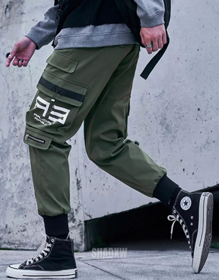 Type: Techwear pants Design: Techwear, streetwear Technical pants: This techwear pants is the perfect garment to complete your Techwear outfit. Premium quality: Reinforced seams, comfortable to wear, soft touch Materials: Polyester Machine washable: 30 °C (86 °F) Size(cm | in) Waist Length Hip S 68 | 26.7 94 | 37 105 | 41.3 M 72 | 28.3 96 | 37.8 110 | 43.3 L 76 | 29.9 98 | 38.6 115 | 45.3 XL 80 | 31.5 100 | 39.4 120 | 47.2 Elevate Your Urban Ensemble with Khaki Pants Streetwear The magic of Khak Winter Baggy Cargo Pants For Sports, Winter Sports Baggy Cargo Pants, Cargo Pocket Pants For Streetwear, Sportswear Pants With Cargo Pockets For Streetwear, Sportswear Cargo Pants For Streetwear, Winter Techwear Cargo Pants For Outdoor, Sporty Streetwear Activewear With Functional Pockets, Functional Baggy Pants For Streetwear, Sporty Activewear With Functional Pockets For Streetwear