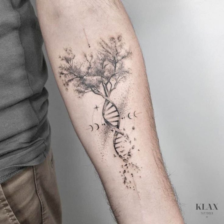 a man's arm with a tree and a tattoo on the left side of his arm