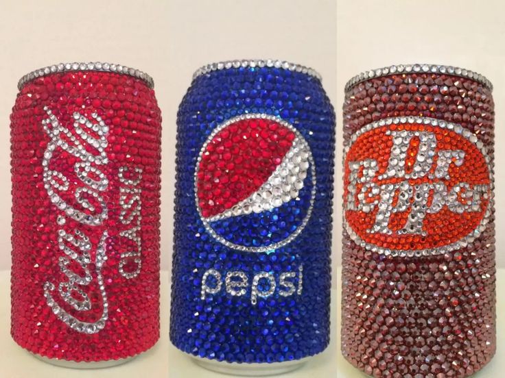 three soda cans covered in swarozak and pepsi logo beads, each decorated with different colors