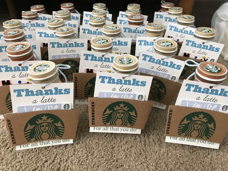 there are many starbucks coffee cups with thank you notes on them and tags attached to the lids