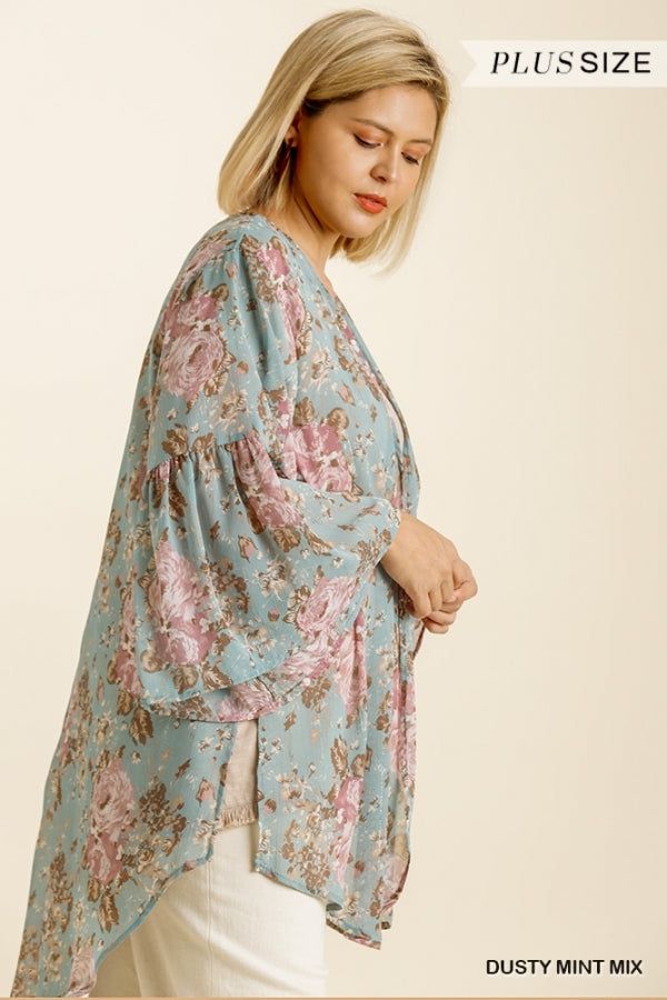 Treat yourself to soft floral comfort with this billowing hi-lo kimono cardigan. The open front and flowing bell sleeves create an effortlessly breezy style, ideal for lazy Sunday morning coffees or cozy movie nights in. The curved hemline and pretty floral print add a touch of feminine charm without saccharine sweetness, instantly elevating the most mundane of everyday outfits. 100% Polyester Want to view this on the *Live* Sizing & Styling Guide?! Watch it in the photo section above! *You will Floral Print V-neck Kimono For Brunch, V-neck Floral Print Kimono For Brunch, Fall V-neck Kimono For Daywear, V-neck Kimono For Fall Daywear, Spring Bohemian Floral Print Cardigan, V-neck Floral Print Kimono For Fall, Flowy Long Sleeve Spring Kimono, Fall Floral Print Kimono For Loungewear, Bohemian Spring Cardigan For Loungewear