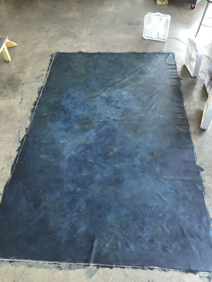 a blue rug is laying on the floor in an empty room with chairs and tables