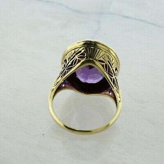 Vintage 14K Yellow Gold 5 ct Amethyst Ring, 11x14mm rich purple amethyst gold bezel halo tooled, .75 inch across, Ring size 6, Circa 1950, 5.5 grams Stock # BB259R16 This listing contains photographs of the actual item you will receive. Our items are in excellent condition with little or no signs of wear and many are one of a kind pre-owned estate finds. Please look closely at the pictures in this listing as they are part of the product description. Please read the description, as any imperfecti Luxury Round Cabochon Amethyst Ring, Formal Purple Cabochon Amethyst Ring, Luxury Purple Cabochon Amethyst Ring, Luxury Purple Amethyst Cabochon Ring, Formal Purple Cabochon Ring, Fine Jewelry Purple Amethyst Cabochon Ring, Purple Amethyst Cabochon Ring Fine Jewelry, Luxury Yellow Gold Amethyst Ring With Bezel Setting, Luxury Gold Amethyst Ring With Bezel Setting