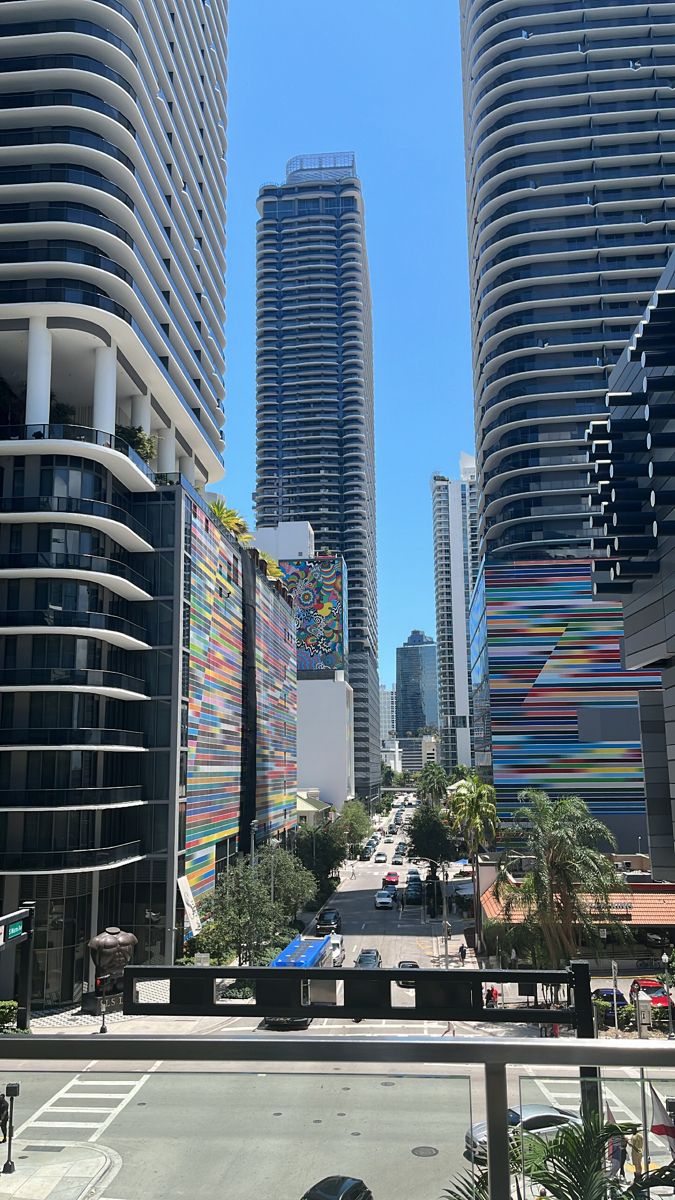 some tall buildings and cars on a city street