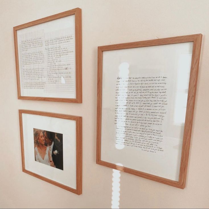 three framed pictures hang on the wall next to each other, with writing in between them