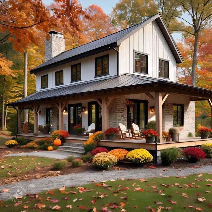 a white house surrounded by fall foliage and trees