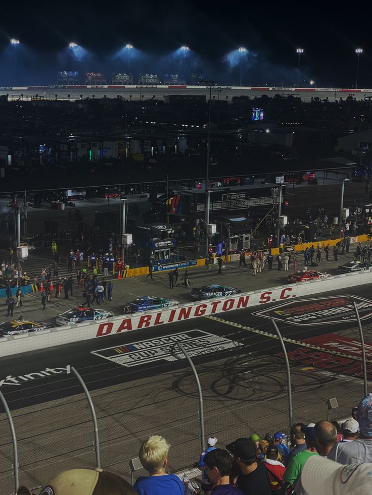 a race track at night with lots of people watching