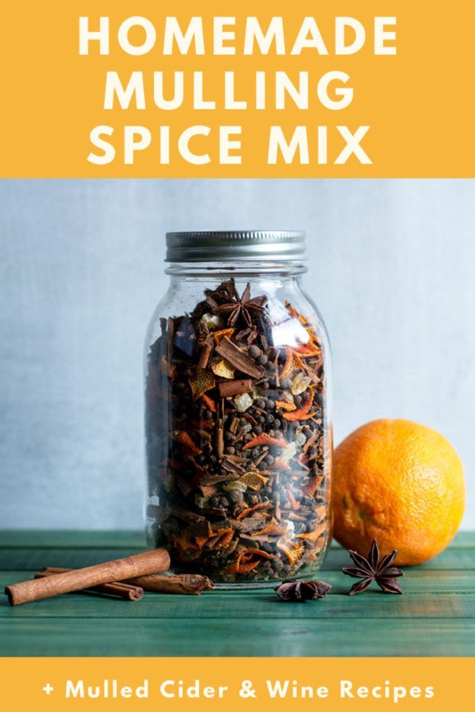 homemade mulling spice mix in a glass jar with an orange and cinnamon stick next to it