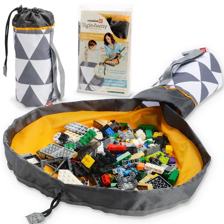 a bag filled with lots of legos next to a book and some other items