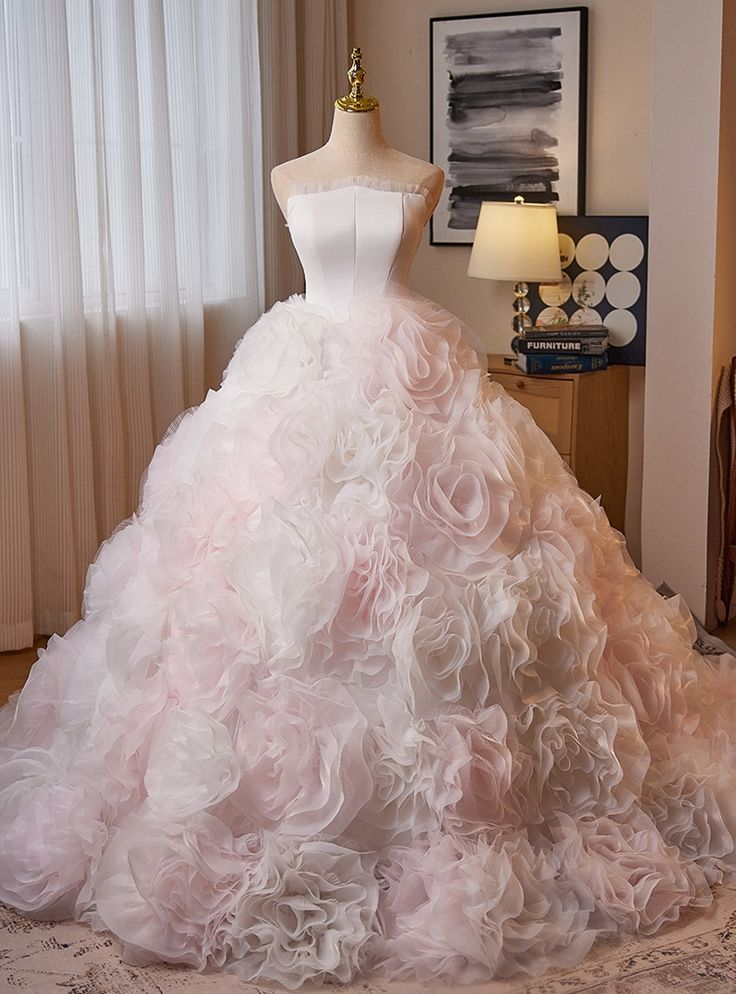 Known for its grandeur, this gorgeous prom dress is a masterpiece of romantic design. The strapless bodice is sleek and understated, allowing the full, floral-inspired skirt to take center stage. The voluminous skirt is composed of cascading layers of tulle, each one forming intricate rosettes that give the dress a unique, textured appearance. The gentle blush and white tones evoke a sense of softness and femininity, while the structured shape ensures a flawless fit. With every movement, the skirt sways gracefully, making this dress perfect for those who want to feel like they’re walking on air. This is the ultimate choice for someone seeking to blend timeless beauty with contemporary flair! Gown For Debut, Gorgeous Prom Dresses, Quinceanera Dress, Blue Tulle, Pink Gowns, White Tulle, Romantic Design, Pink Tulle, Prom Night