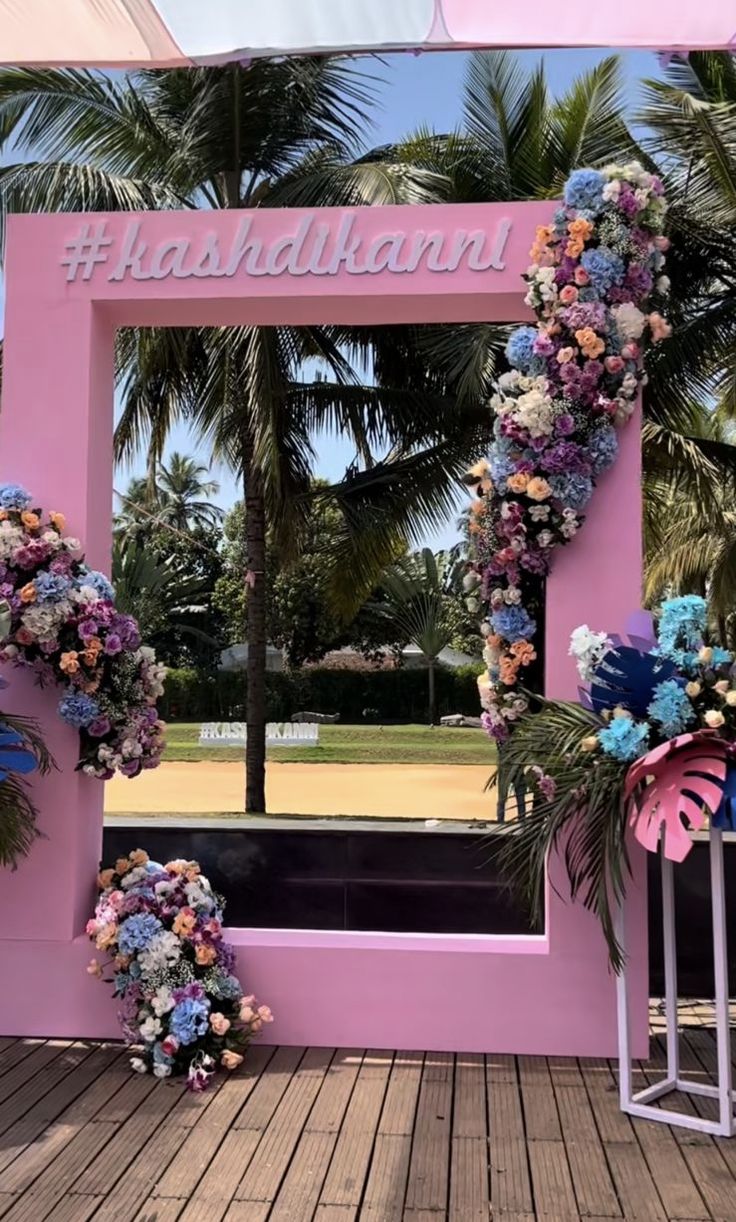 a pink frame decorated with flowers and palm trees