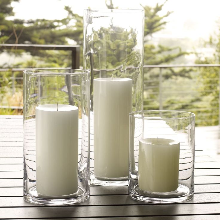 some candles are sitting on a table with the words west elm in front of them