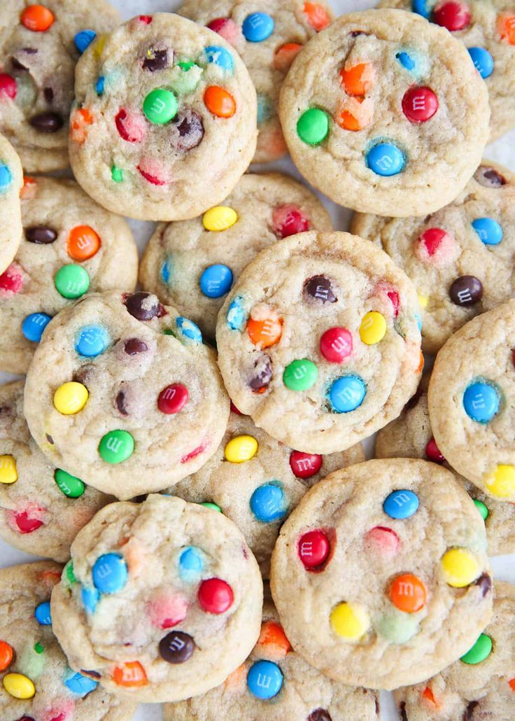 m & m cookies with m and m candies in the middle on a white plate