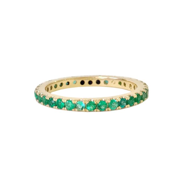 "This finely handcrafted ring is made completely of 14K solid gold and pavé set with genuine AAA quality round brilliant cut natural real Colombian Emerald gemstones. Perfect for stacking. ♦ Band Width: approximately 2.3mm ♦ Metal Finish: High Shine Polish ♦ This design is available in Rose, White and Yellow 14K Gold; also in 14K White Gold with Black Rhodium Plated Finish ♦ Please note that this item takes about 3 to 5 business days for production, prior to shipping. ♦ This item is proudly made Emerald Eternity Band With Prong Setting Gift, Classic Green Stackable Eternity Band, Classic Green Eternity Band As A Gift, Green Eternity Band With Prong Setting As Gift, Green Round Eternity Band In Fine Jewelry, Emerald Eternity Band In Yellow Gold As Gift, Green Round Eternity Band Fine Jewelry, Fine Jewelry Green Round Eternity Band, Emerald Eternity Band With Round Cut As Gift