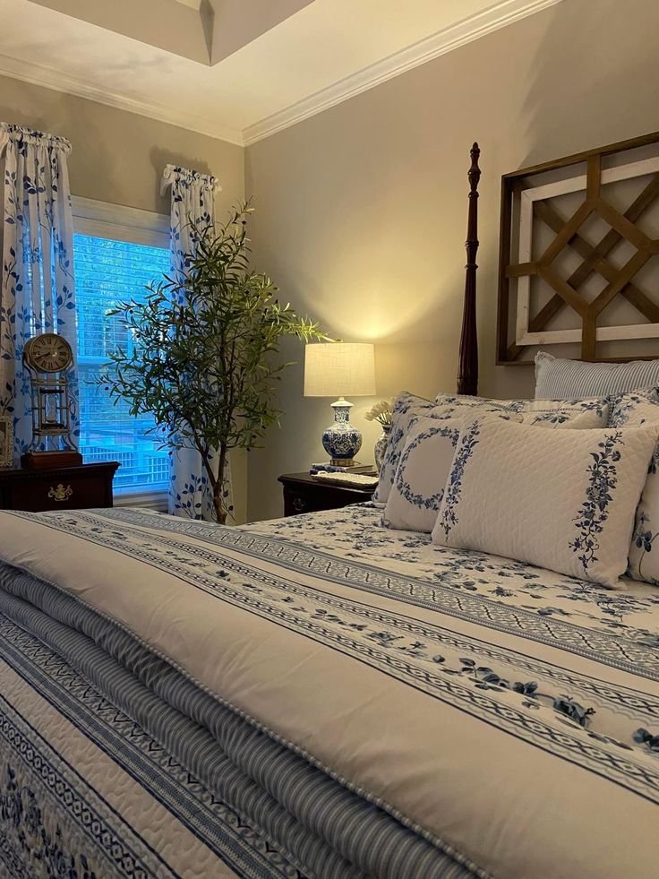 a bedroom with a large bed and blue curtains