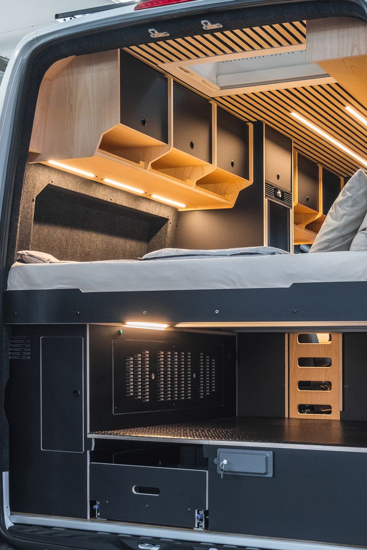 the bed in the back of a van is built to look like it has been converted