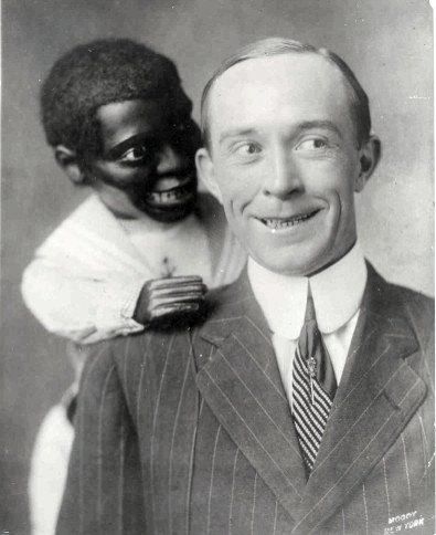 an old black and white photo of a man with a mask on his face holding a woman's head