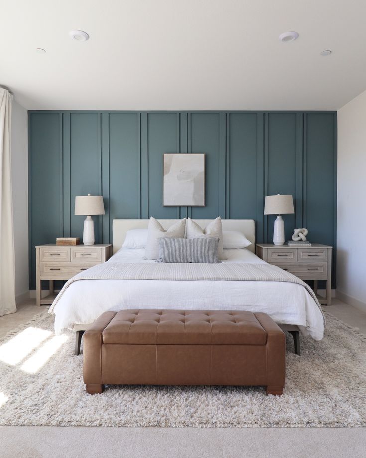 a large white bed sitting in a bedroom next to two lamps