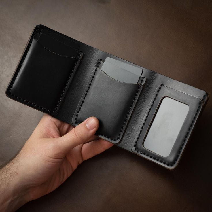 This is a substantial leather trifold wallet.When you're out for dinner with friends, they will notice when you throw this wallet on the table. A loud thud followed by eyes fixed on this beautifully constructed piece will make an impression. Immaculate hand-stitching and full-grain Horween leather compliment a smartly designed, but hefty wallet.This full-grain Horween leather wallet is designed to hold a lot of cards and a lot of cash. Easily flip out your ID when it's needed and the wallet will Full Grain Leather Wallet, Mens Card Holder, Leather Trifold Wallet, Leather Supplies, Engraved Initials, Horween Leather, Leather Workshop, Flip Out, Dinner With Friends