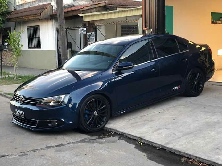 a blue car parked in front of a building