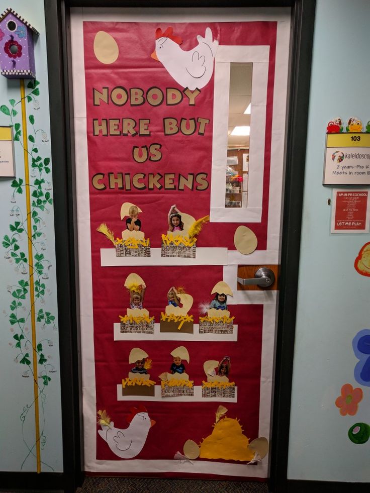 a door decorated with pictures and words in the shape of chickens, on display at a children's playroom