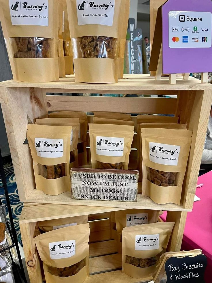 several bags of food are stacked on top of each other in front of a sign