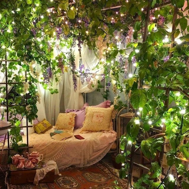 a room with lots of plants and lights on the ceiling