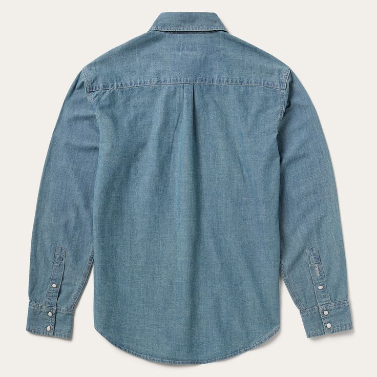 This snap-front western shirt is crafted from 100% cotton chambray denim that’s been garment washed for a lived-in feel, and made to get softer and more comfortable with time. It has one open pocket, no front yoke, a straight back yoke with pleat, one-snap cuffs and contrast cream topstitch. Cut trim for a modern fit, the shirt is finished with logo pearl snaps and subtle Stetson embroidery that speaks to our commitment to quality. Hard-wearing and built to last, our denim shirts are defined by Washed Blue Chambray Button-up Denim Top, Classic Pre-washed Denim Tops, Classic Denim Tops Pre-washed, Classic Chambray Button-up Denim Top, Collared Denim Blue Chambray Top, Fall Washed Blue Chambray Denim Top, Classic Light Wash Denim Top With Button Closure, Classic Denim Blue Shirt With Snap Buttons, Unstructured Denim Shirt With Button Closure