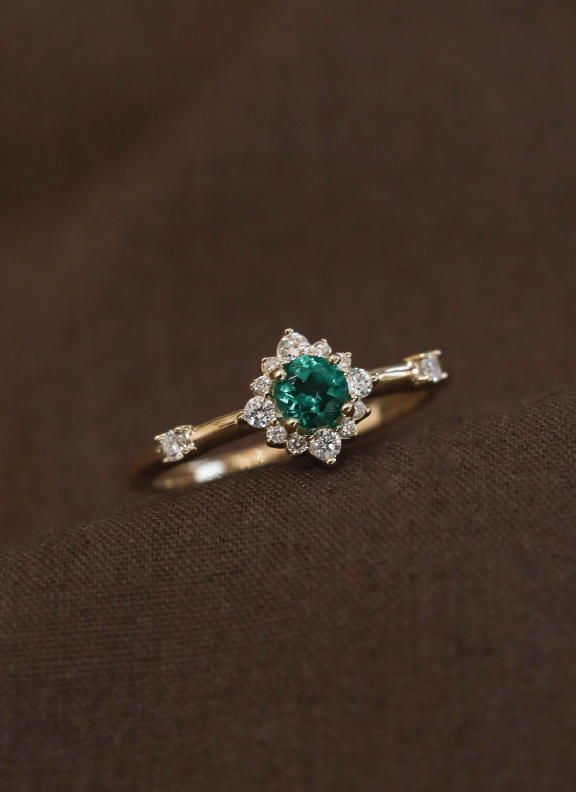 14k yellow gold | 4.10mm round emerald gemstone center stone Formal Diamond Ring With Halo For May Birthstone, Green Emerald Ring With Halo Round Cut, Emerald Ring With Brilliant Cut For Promise, Timeless Green Diamond Round Ring, Luxury Emerald Ring With Halo And Round Cut, Classic Green Diamond Halo Ring, Emerald Diamond Promise Ring, Diamond May Birthstone Ring, Promise Emerald Ring With Diamond