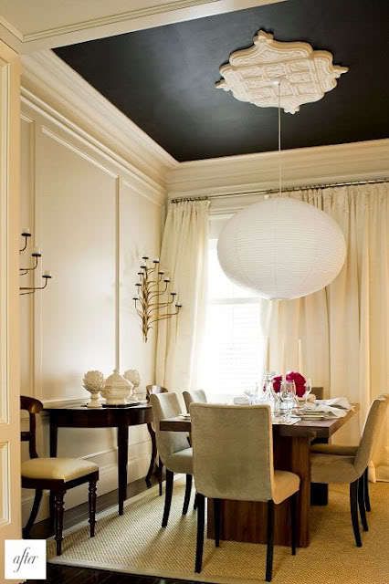 a dinning room table with chairs and a chandelier hanging from the ceiling