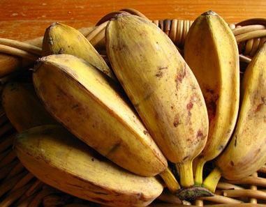 a bunch of ripe bananas sitting in a wicker basket on top of a table