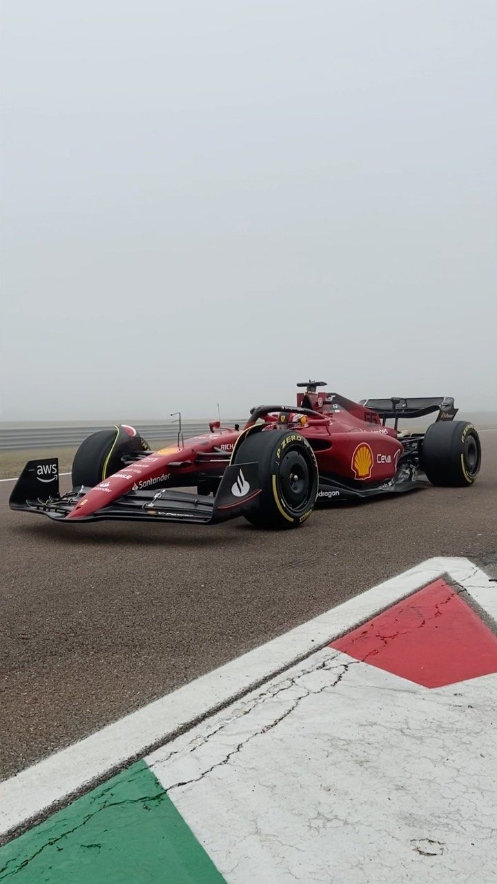 a red race car is driving on the track