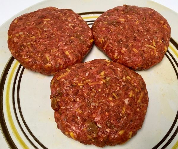 three hamburger patties sitting on top of a plate