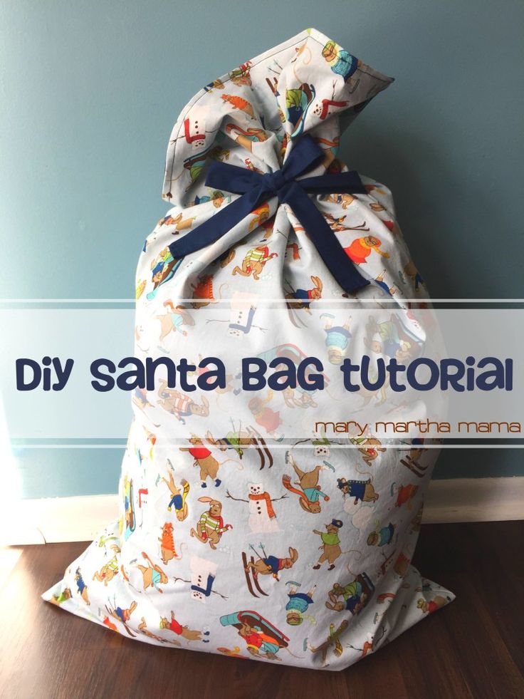 a bag sitting on top of a hard wood floor next to a wall with the words diy santa bag tutor