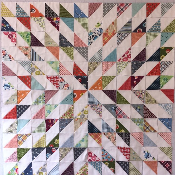 a quilt made with different colors and patterns on the front, side, and back