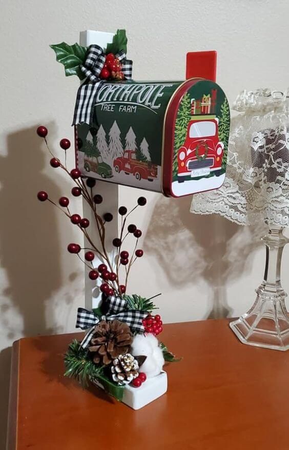 a mailbox decorated with christmas decorations on a table