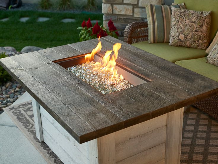 a fire pit sitting on top of a wooden table