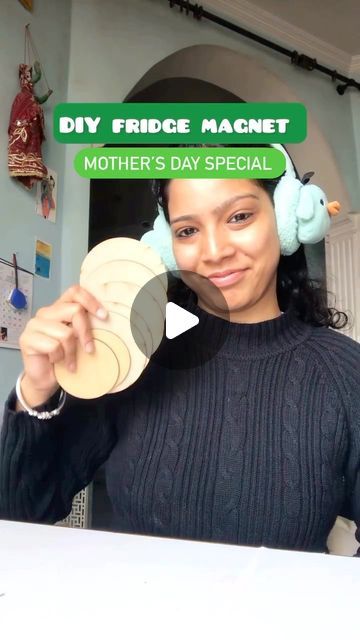 a woman wearing headphones is holding up a piece of paper that reads diy fridge magnets mother's day special