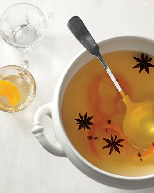 a white bowl filled with liquid next to two glasses