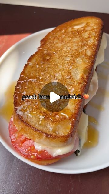 a grilled cheese and tomato sandwich on a white plate