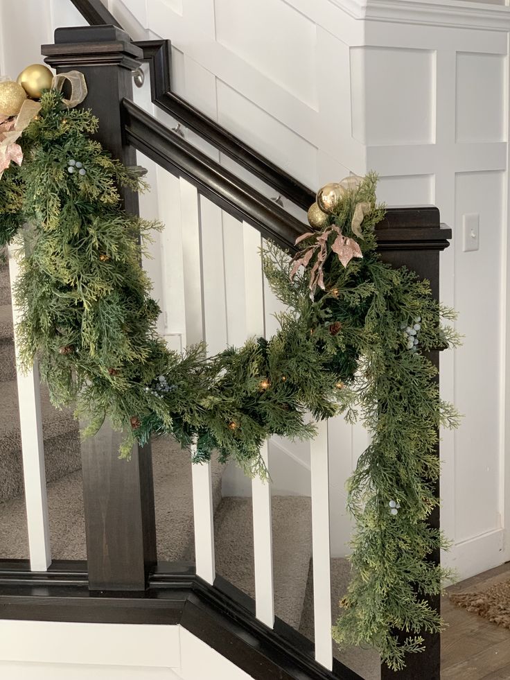 christmas garland on the banisters at the bottom of stairs