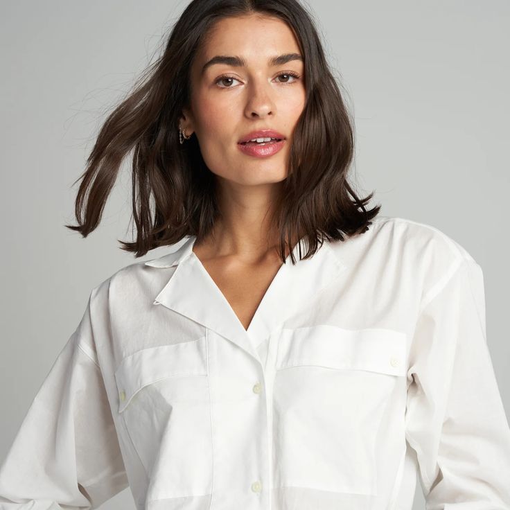 The Fay Utility Camp Shirt is roomy and relaxed but decidedly feminine and sophisticated. Crafted from cotton lawn, a lightweight yet durable fine thread poplin, the Faye has a silky-smooth hand feel. Its unique features include a lay-flat camp collar with an elevated top button and loop closure, wide-set center front Modern Blouse With Spread Collar For Daywear, Relaxed Fit Collared Blouse For Daywear, Relaxed Fit Blouse With Collared Neckline For Daywear, Relaxed Fit Shirt With Collared Neckline For Daywear, Daywear Shirt With Placket And Camp Collar, Daywear Blouse With Camp Collar, Sleeve Placket, Bone White, Camp Shirt