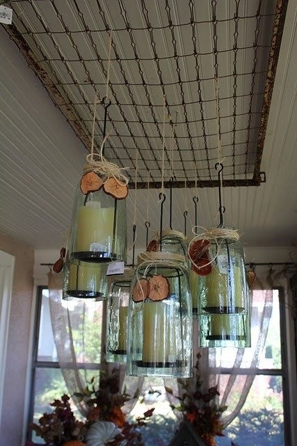 mason jars filled with candles hanging from a ceiling