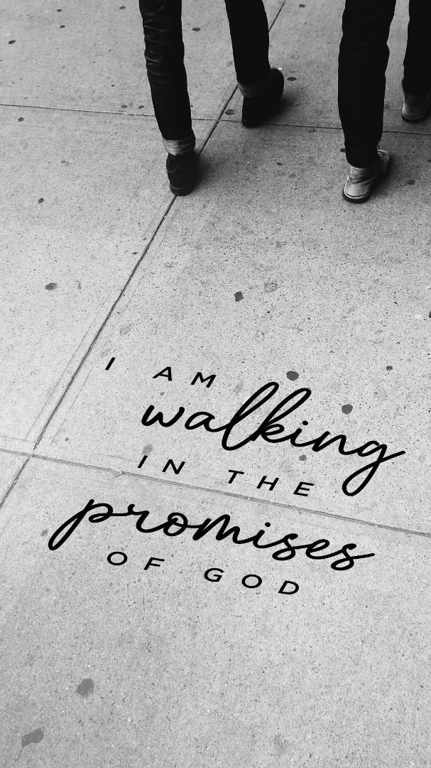 two people walking down a sidewalk with writing on the ground next to them that says, i am walking in the promise of god